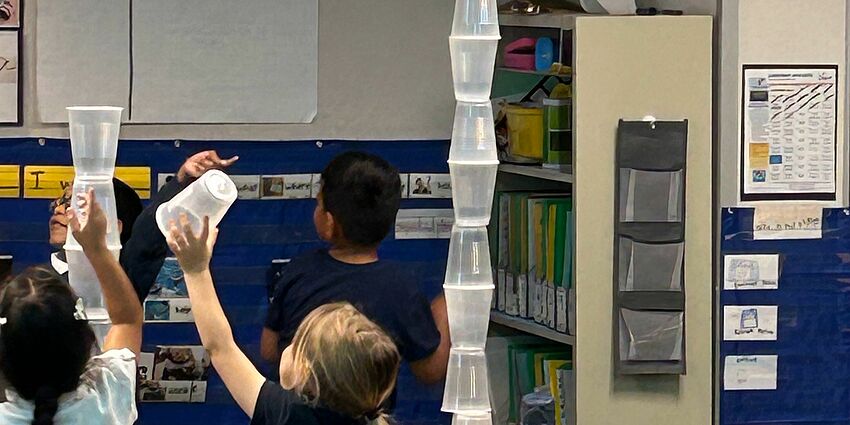 Students building with plastic cups