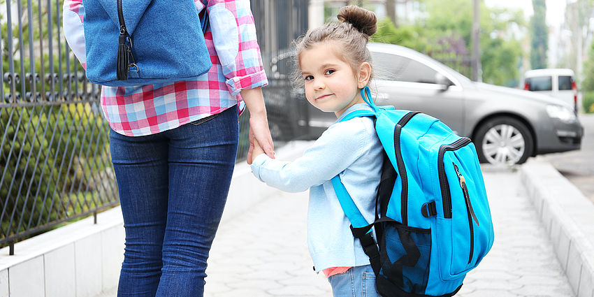 parent and child walk to school