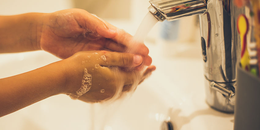 child washing hands