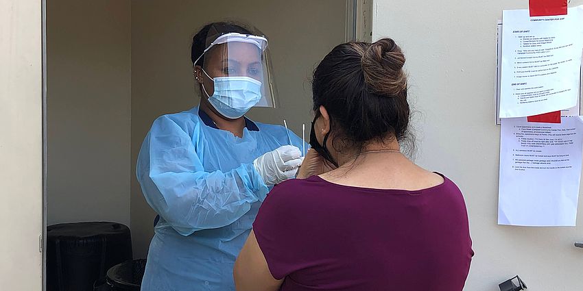 woman administering covid test to another woman