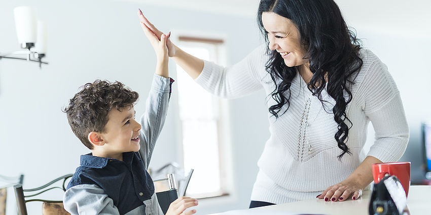 child and parent high fiving