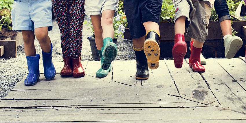 children's feet in boots taking a step forward