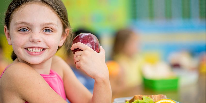 smiling child with an apple