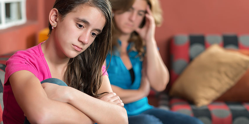 sad teen girl and worried mother
