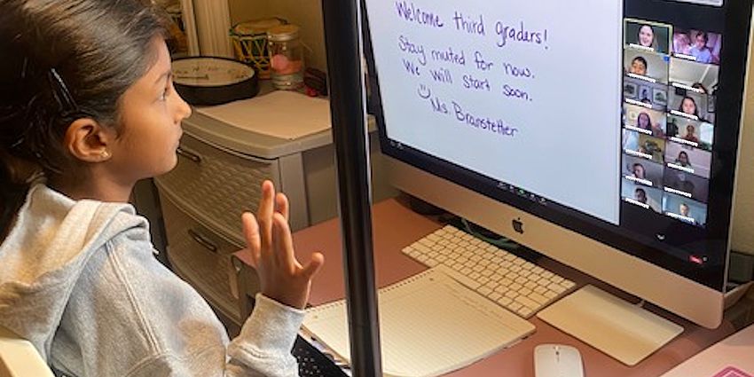 girl sitting at computer and learning at home 