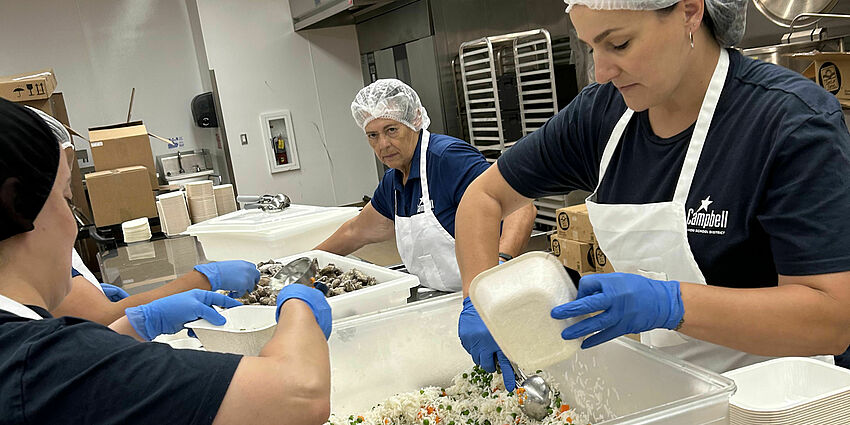 Ladies prepping lunches in the central kitchen.