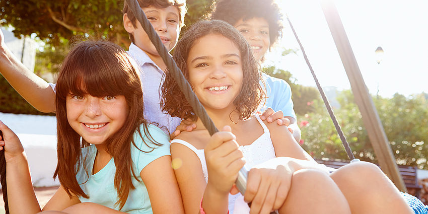 group of smiling kids at playground