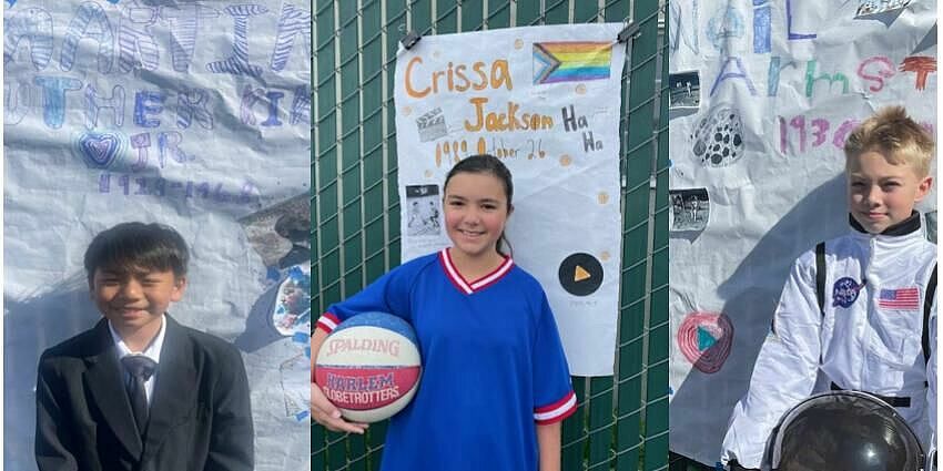 Three children dressed as Barack Obama, Crissa Jordan and Neil Armstrong stand in front of posters with information about them. 