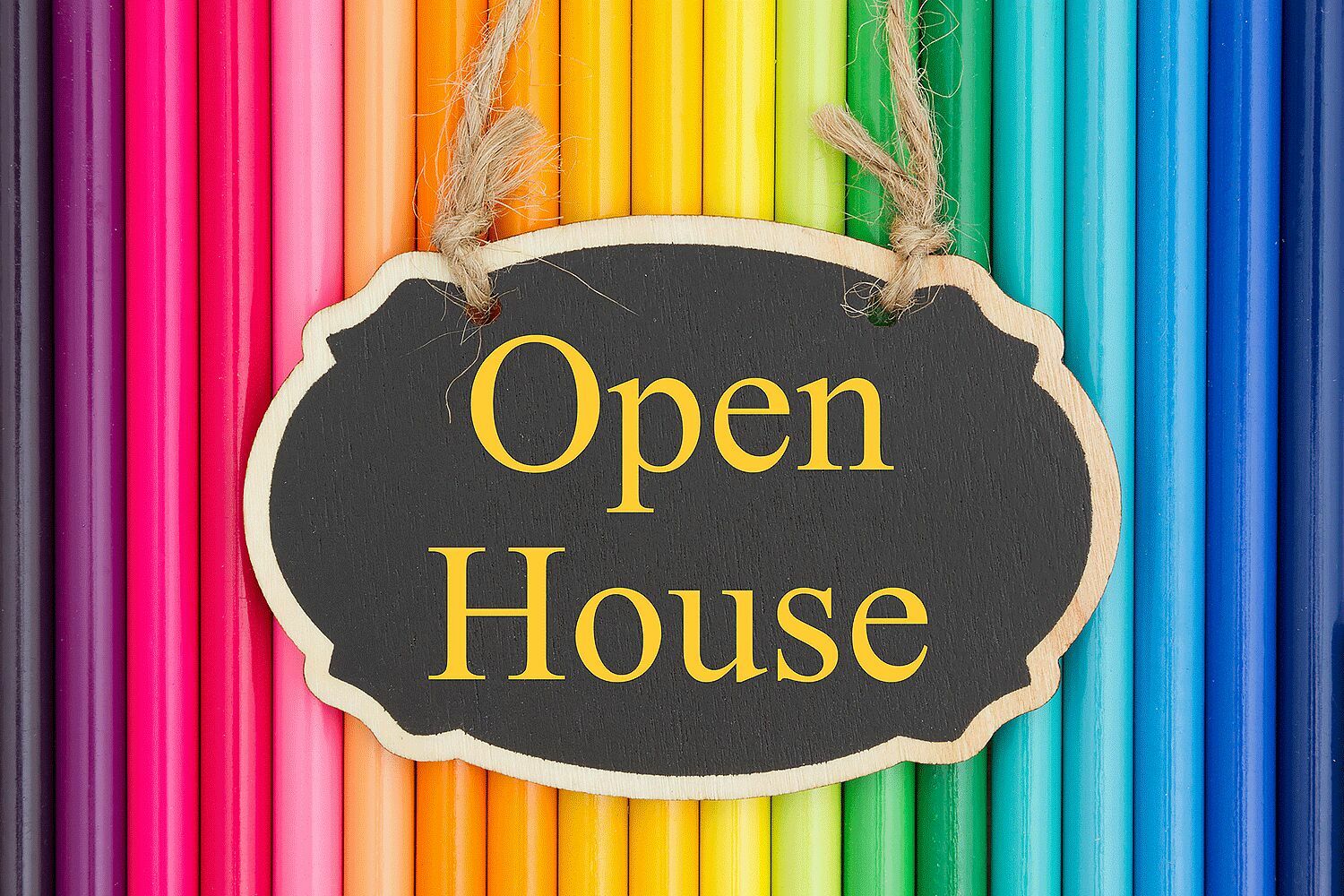 colored pencils with sign for open house